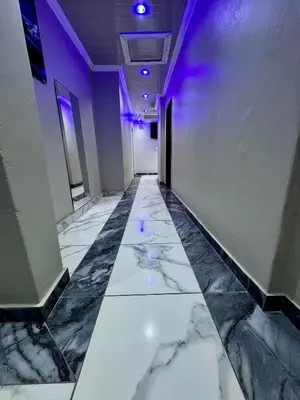 a hallway with a marble floor and purple lights at Kitty Guest House in Bellville