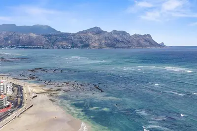 an aerial view of a beach with mountains in the background at 14 Cap dAzur by Host Agents in Cape Town