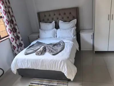 a bedroom with a bed with a robe on it at Gift Guest house 2 in Cravenby