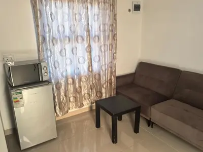 a living room with a couch and a small table at Gift Guest house 1 in Cravenby