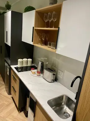 a kitchen with a sink and a counter top at On Park Century City Cozy Apartment in Cape Town
