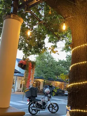 a motorcycle parked next to a building with lights at Studio 5 at Huis Piron in Stellenbosch