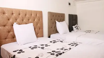 two beds in a hotel room with white pillows at Gift Guest house 3 in Cravenby