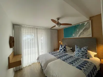 a bedroom with a bed with a ceiling fan and a window at Gordonia Unit 9 Gordons Bay in Gordonʼs Bay