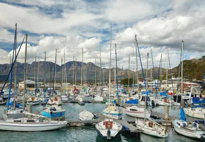 a bunch of boats are docked in a harbor at Gordonia Unit 9 Gordons Bay in Gordonʼs Bay