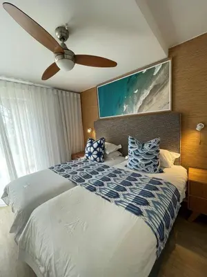 a bedroom with a bed with a ceiling fan at Gordonia Unit 9 Gordons Bay in Gordonʼs Bay