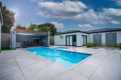 a swimming pool in the backyard of a house at Winelands Escape in Durbanville
