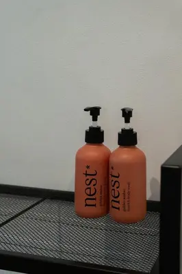 two bottles of disinfectants sitting next to a wall at Apartment Paradys - Serviced in Stellenbosch