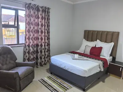 a bedroom with a bed and a chair and a window at Gift guest house 4 in Cravenby
