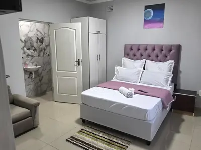 a bedroom with a bed and a chair and a door at Gift guest house 4 in Cravenby
