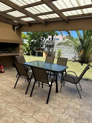 a black table and chairs on a patio at Hideaway Haven in Cape Town