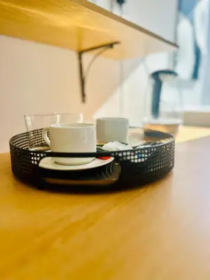 a black basket with two cups and plates on a table at Hideaway Haven in Cape Town