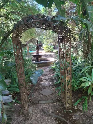 an archway with a fountain in a garden at Timeless at Rusticana in Klapmuts
