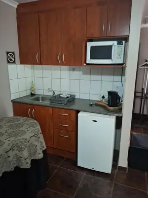 a kitchen with a white refrigerator and a microwave at Timeless at Rusticana in Klapmuts
