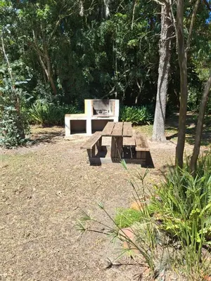 a picnic table and bench in a park at Timeless at Rusticana in Klapmuts