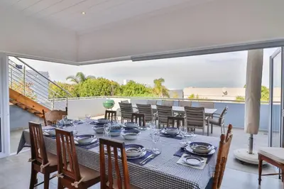 a dining room with a table and chairs at Vonkelwyn - enjoy Grotto Beach sunsets in Hermanus