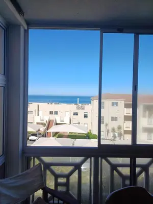 a view of the ocean from a balcony at Beach Club 150 Hermanus in Hermanus