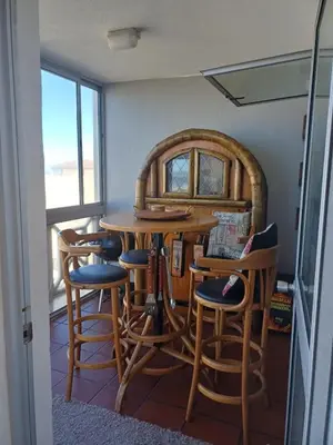 a room with a table and some chairs at Beach Club 150 Hermanus in Hermanus