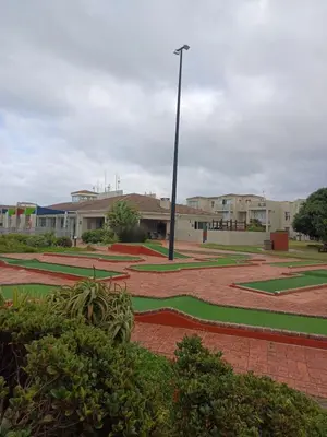 a courtyard with a light pole and some buildings at Beach Club 150 Hermanus in Hermanus