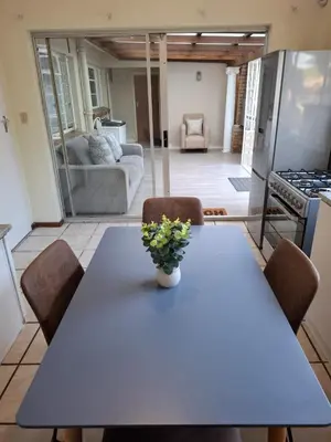 a dining room table with a vase of flowers on it at Chez Yves 2 in Hoheizen