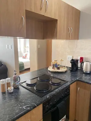 a kitchen with a stove top oven in a kitchen at Melk Tert - Paarl - Self Catering Apartment in Paarl