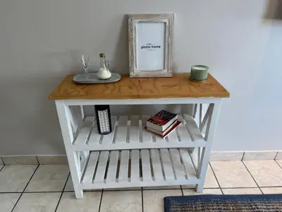 a white table with a shelf and a mirror and books at Melk Tert - Paarl - Self Catering Apartment in Paarl
