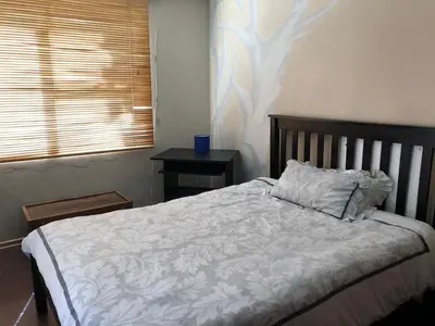 a bedroom with a bed with a pillow and a window at Home from Home in Welton