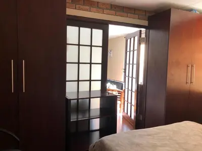 a bedroom with a door open to a room with a bed at Home from Home in Welton
