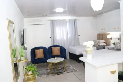 a bedroom with a bed and a couch and a table at Optimum Stay Self Catering Accommodation - Twin Room 2 Single Beds in Parow