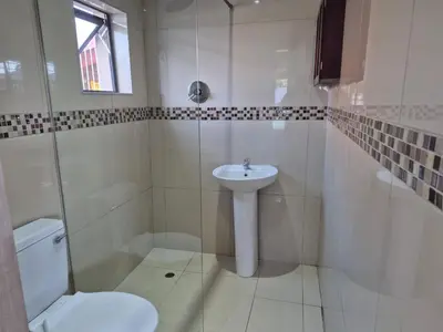 a white bathroom with a sink and a toilet at Maglovir Economy in Tiervlei