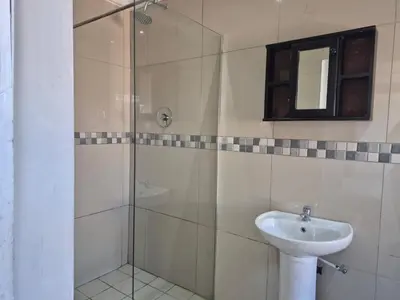 a bathroom with a shower and a sink at Maglovir Economy in Tiervlei