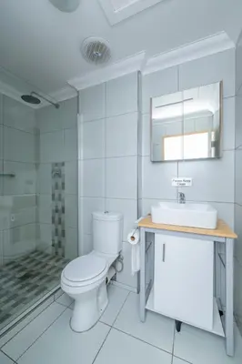 a bathroom with a toilet and a sink and a shower at Prime Apartments in Richwood