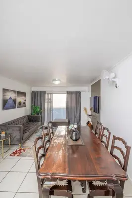 a living room with a wooden table and chairs at Prime Apartments in Richwood