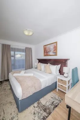 a bedroom with a large bed and a window at Prime Apartments in Richwood