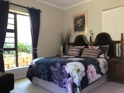 a bedroom with a bed and a window at Charming Self-Catering Apartment in Tygerberg Hills
