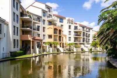 a river in front of some apartment buildings at Canal Front Apartment Cape Town in Cape Town