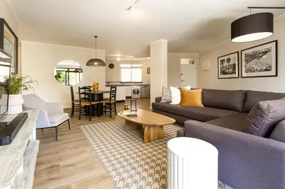 a living room with a couch and a table at Canal Front Apartment Cape Town in Cape Town