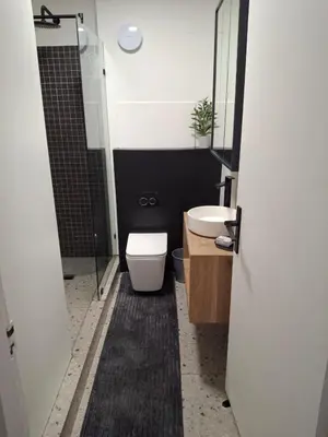 a bathroom with a toilet and a sink and a shower at Splendour on Dorp in Stellenbosch