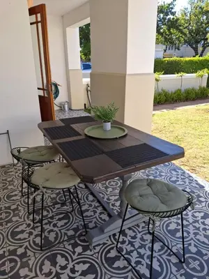 a wooden table and four chairs on a patio at Splendour on Dorp in Stellenbosch