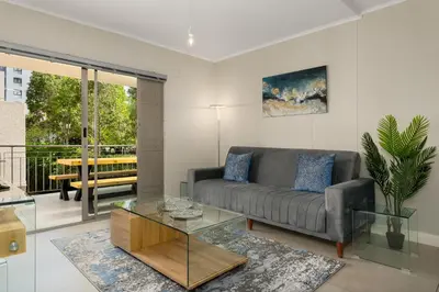a living room with a couch and a table at Mayfair 134 in Cape Town