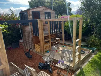 a play house with chairs and a swing at Spacious Modern Home, Paarl Winelands in Paarl