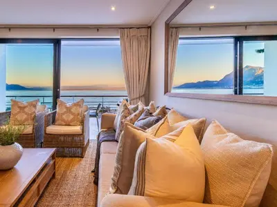 a living room with couches and a view of the ocean at 74 on Marine in Hermanus