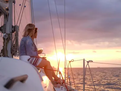 a woman sitting on a sail boat at sunset at 74 on Marine in Hermanus
