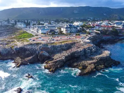 an aerial view of a coastal town on the ocean at 74 on Marine in Hermanus