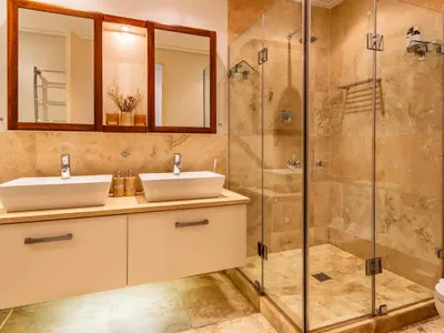 a bathroom with two sinks and a shower at 74 on Marine in Hermanus