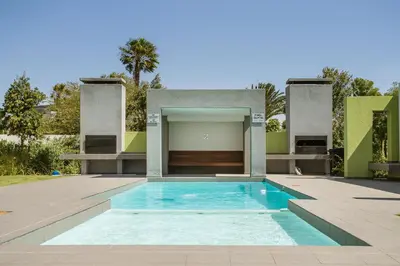 a swimming pool in the backyard of a house at Apartments on Century in Cape Town