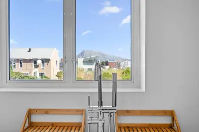 a kitchen sink in front of a window at Metalasia Four in Bettyʼs Bay