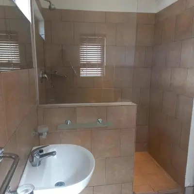 a bathroom with a sink and a mirror at Overnight Lodge in Cape Town