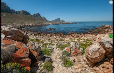 a rocky beach with rocks and the ocean at Klein-Hangklip Remote Mountain Studio Cottage in Rooiels