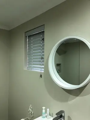 a bathroom with a mirror and a sink at Three on Firmount in Somerset West